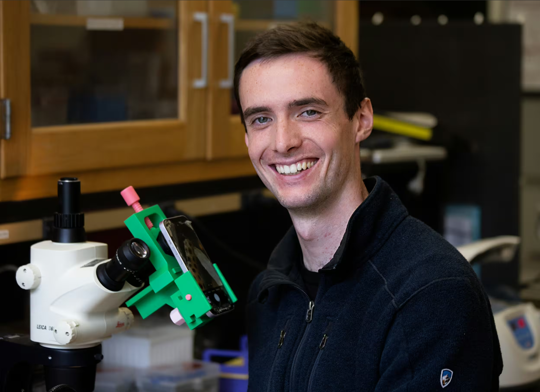 Danny Collins examines coral fragments at the Palumbi Lab.