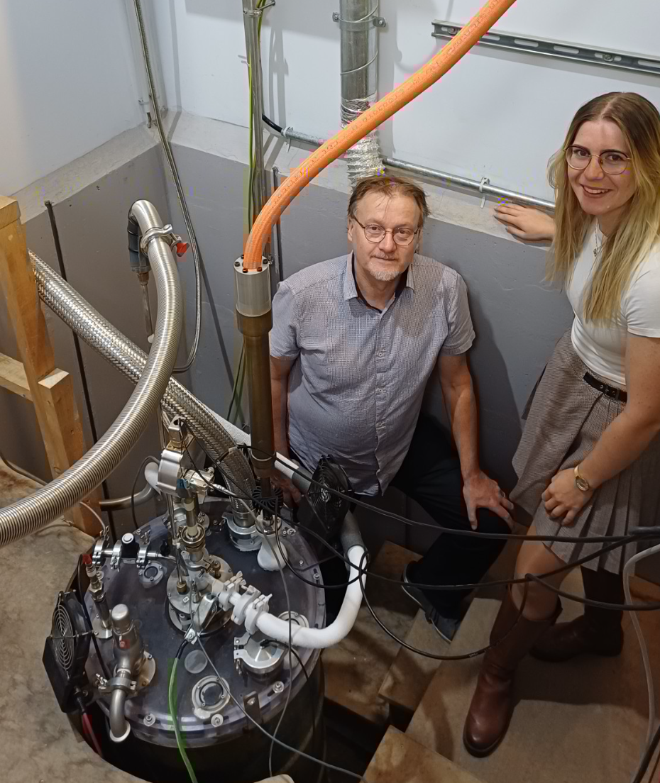 Study authors Professor Nigel Hussey and Dr Caitlin Duffy alongside a cryogenic vessel containing a high field magnet, part of the European Magnetic Field Laboratory (EMFL) infrastructure. Having access to such very high magnetic field strengths was vital for this research.