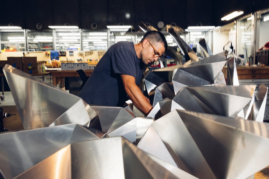 Alfonso Parra Rubio, a graduate student in the Center for Bits and Atoms (CBA) at MIT, works on a foldable metal sculpture.