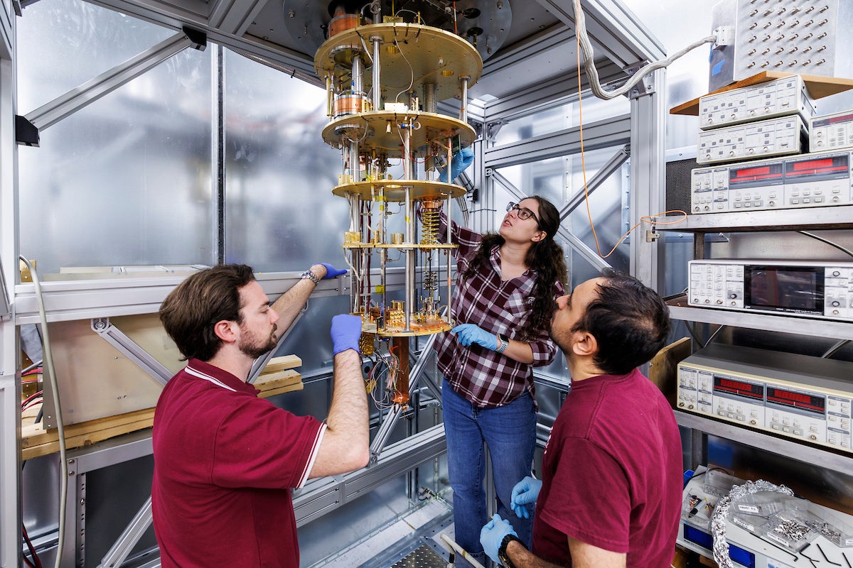 Graduate students, from left, Keith Hunter, Bailey Pickard and Mahdi Mirzakhani mounting detectors.