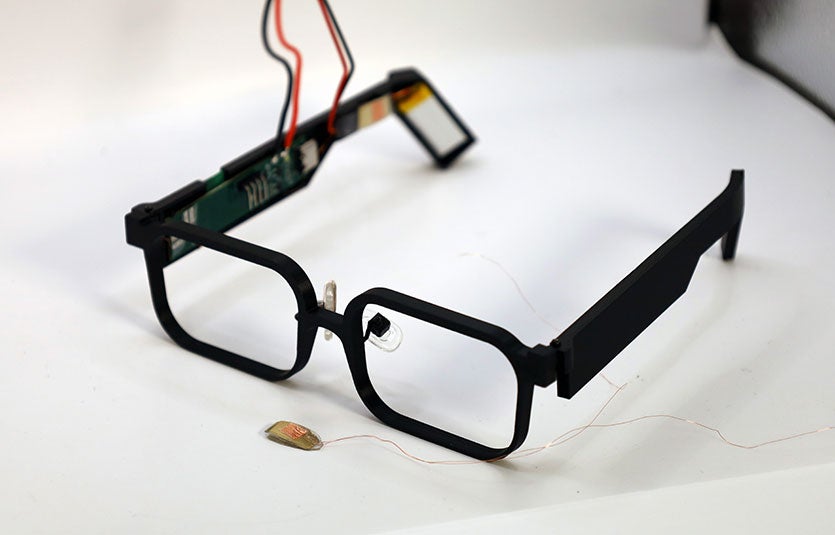 The GlassTENG prototype is shown next to one of the tiny, thin, lightweight sensors.