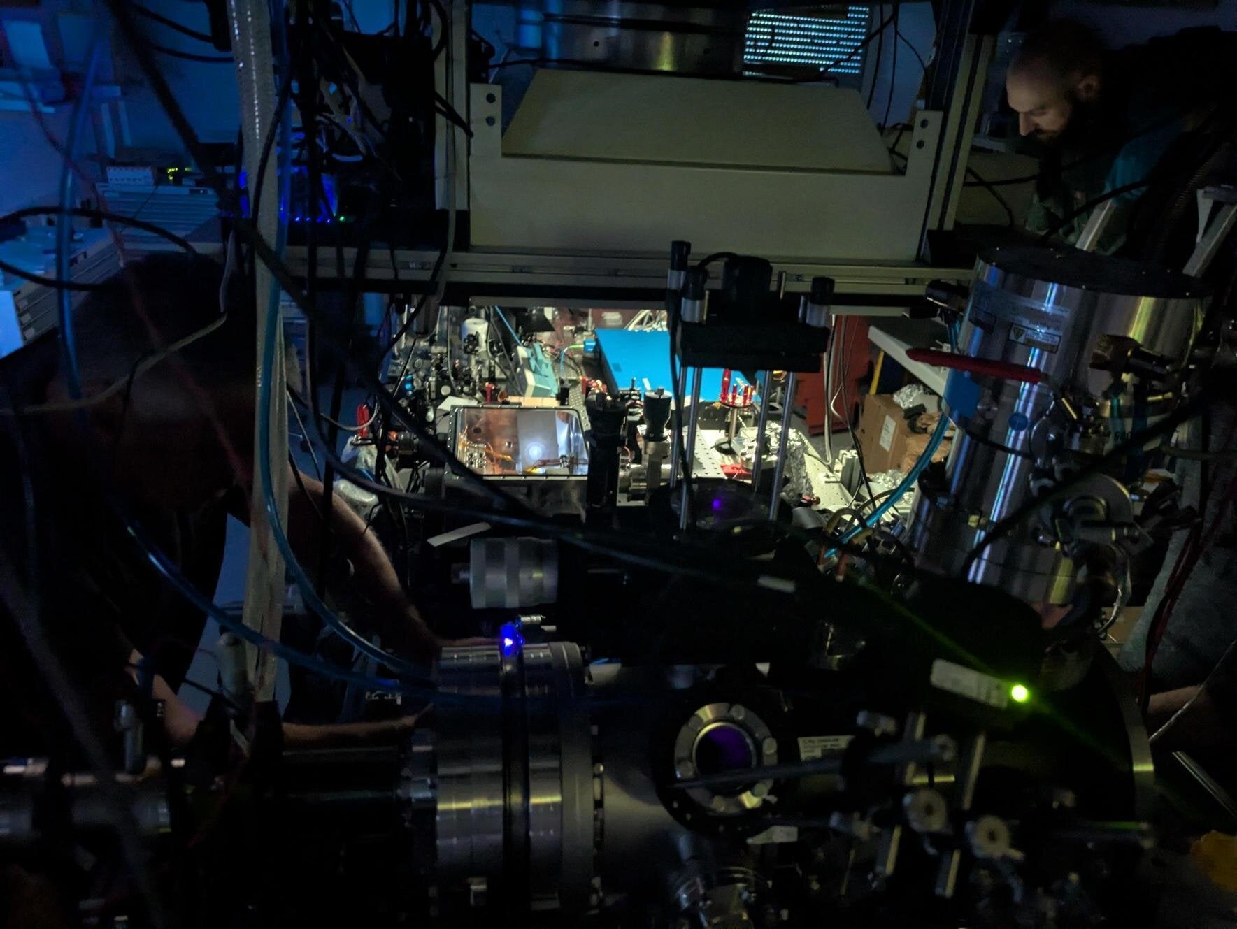 Luca Toscani de Col (top right) working on the nuclear clock in the Vienna lab. 