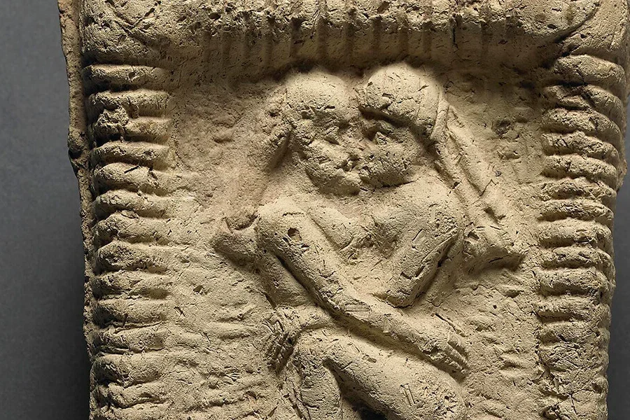 Babylonian clay model showing a nude couple engaged in kissing. Date: 1800 BC.
