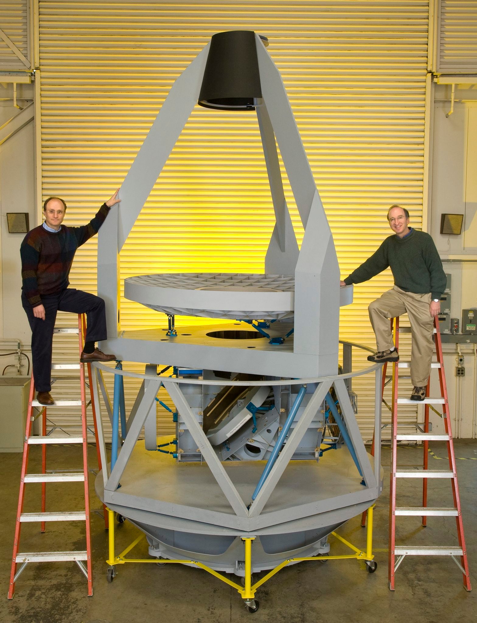 Saul Perlmutter (right) and Michael Levi in 2008 with a prototype of the proposed Supernova Acceleration Probe (SNAP). Over the next decades, SNAP would evolve into the Nancy Grace Roman Telescope.